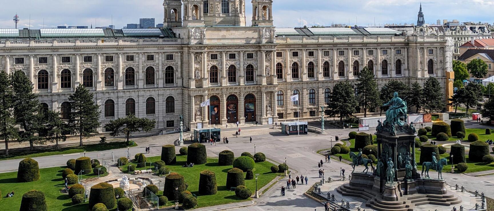 Kunsthistorisches Museum Vienna with dome, Maria Theresa Monument and manicured park in foreground.