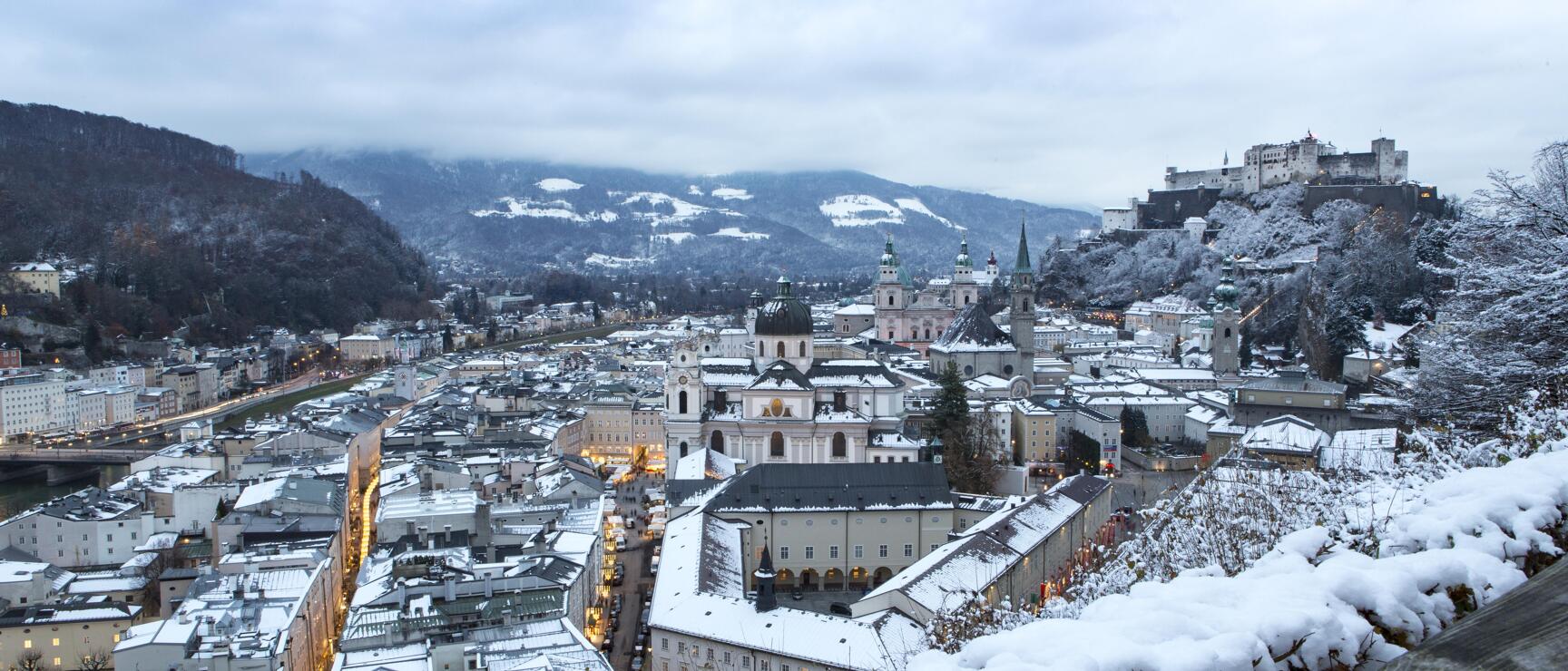 The fortress Hohensalzburg thrones over the snow covered city of Salzburg