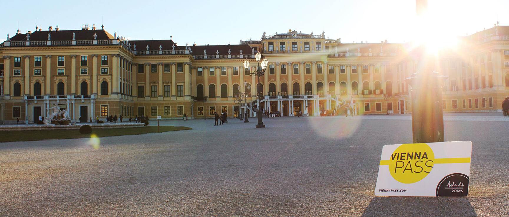Vienna Pass (2 Days, Adult) in front of Schönbrunn Palace in Vienna, sunlight with backlighting.