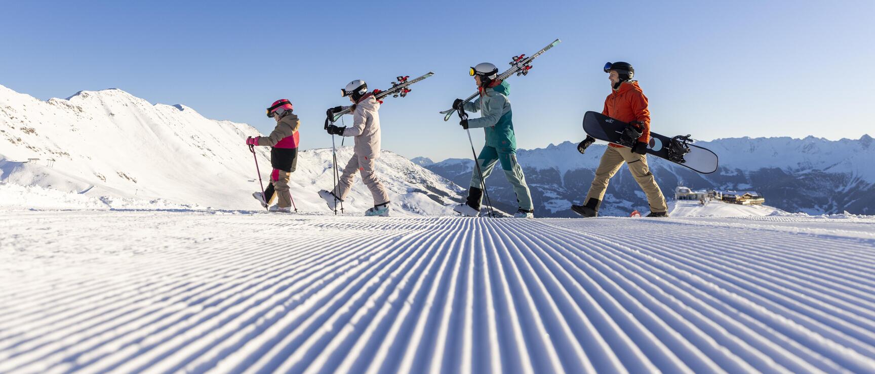 Family on the ski slope in the morning sun