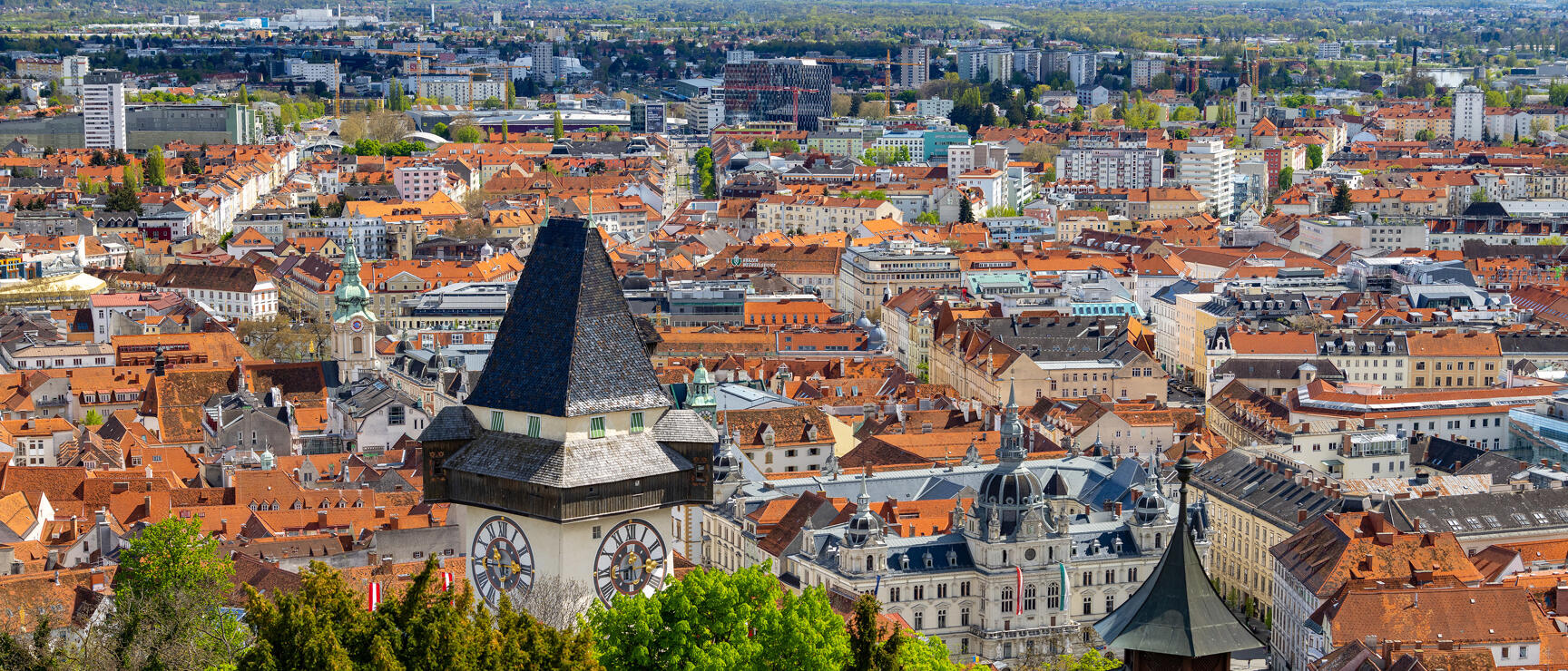 View from Schlossberg of Graz Clock Tower, Town Hall and red-tiled roofs of the old town.