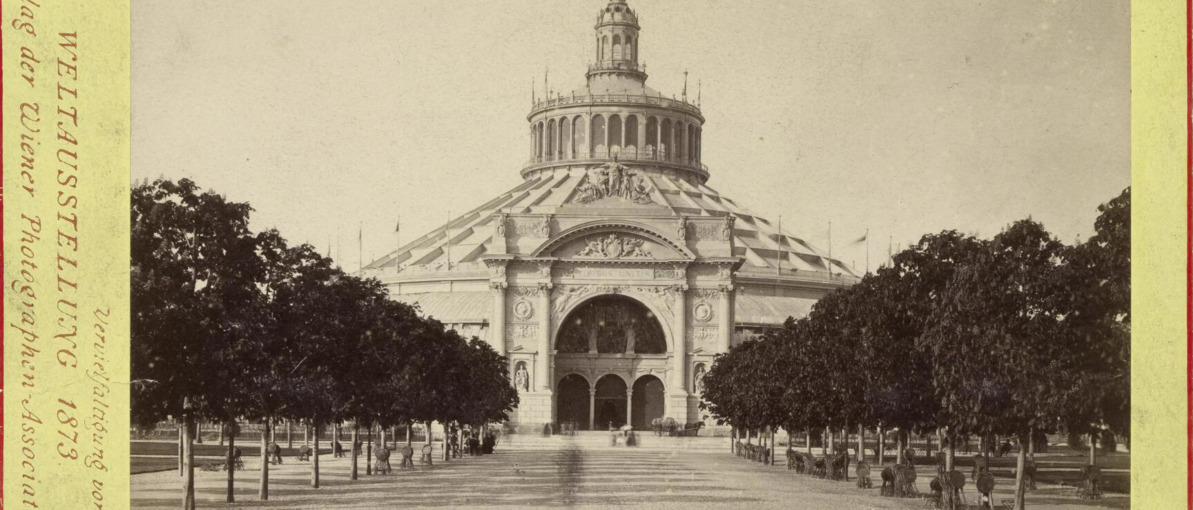 Historic photograph of the Rotunda with south portal, Vienna World's Fair 1873, lined with rows of trees.