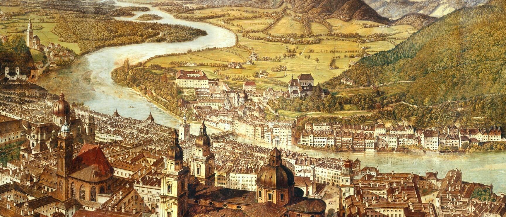 The Sattler Panorama offers a detailed view of the historic city of Salzburg, featuring the Old Town, Salzburg Cathedral, and the winding Salzach River, all set against a sweeping landscape of fields and hills.