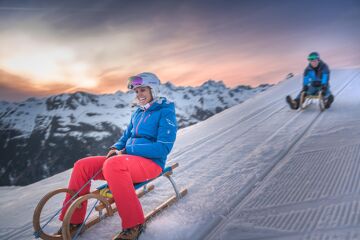 Couple night tobogganing in Ischgl