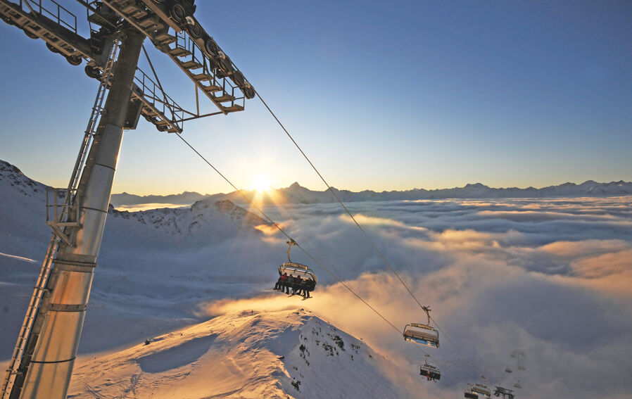 Travelling by ski lift at sunset in East Tirol