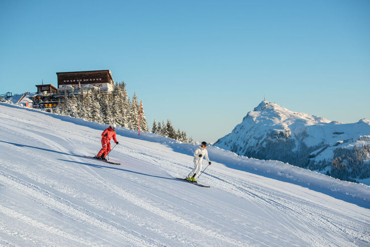 Two skiers on a freshly groomed slope